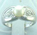 ring with a butterfly knot design and pearl in the center