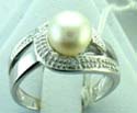stamped 925, sterling silver ring with knot pattern holding a white pearl 