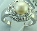 stamped 925, sterling silver ring with round white pearl forming a flower pattern