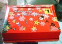 red color Christmas box with star and snowman pattern